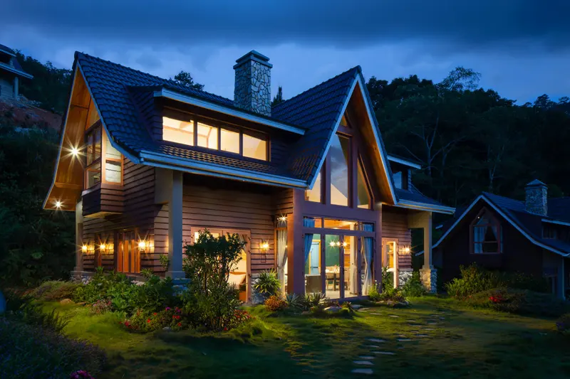 Modern home lit up at dusk