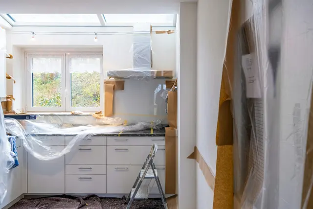 Kitchen renovation progress with exposed framing
